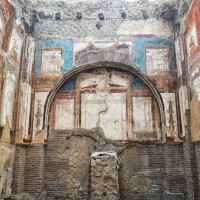 Admire the colourful frescoes of Herculaneum's villas