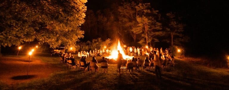 Crowds celebrate around a bonfire