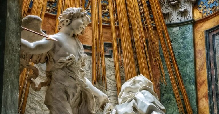Statue of St Teresa in Ecstasy with an angel above her in the church of Santa Maria in Vittoria Rome
