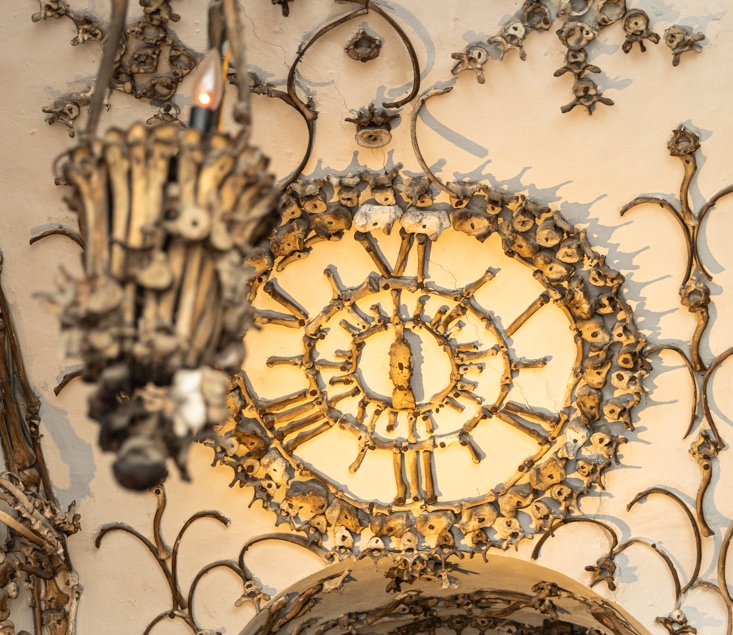 Ceiling of the Capuchin Crypt in Rome showing a clock made from human finer bones and a chandelier made from human bones