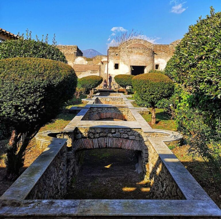 House of Julia Felix in Pompeii showing it's elaborate gardens with canals and bridges surrounded by shrubbery