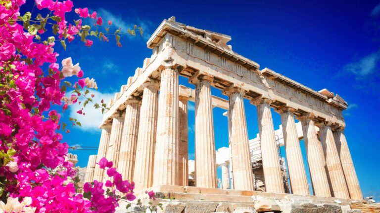 The Partheon in athens with pink bougainvillea in the foreground