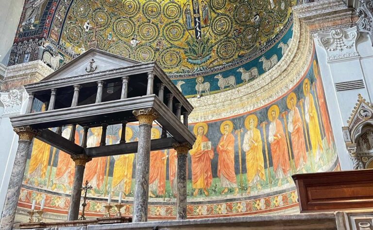 View of the golden apse mosaics of the Basilica of San Clemente with the baldacchino in the foreground