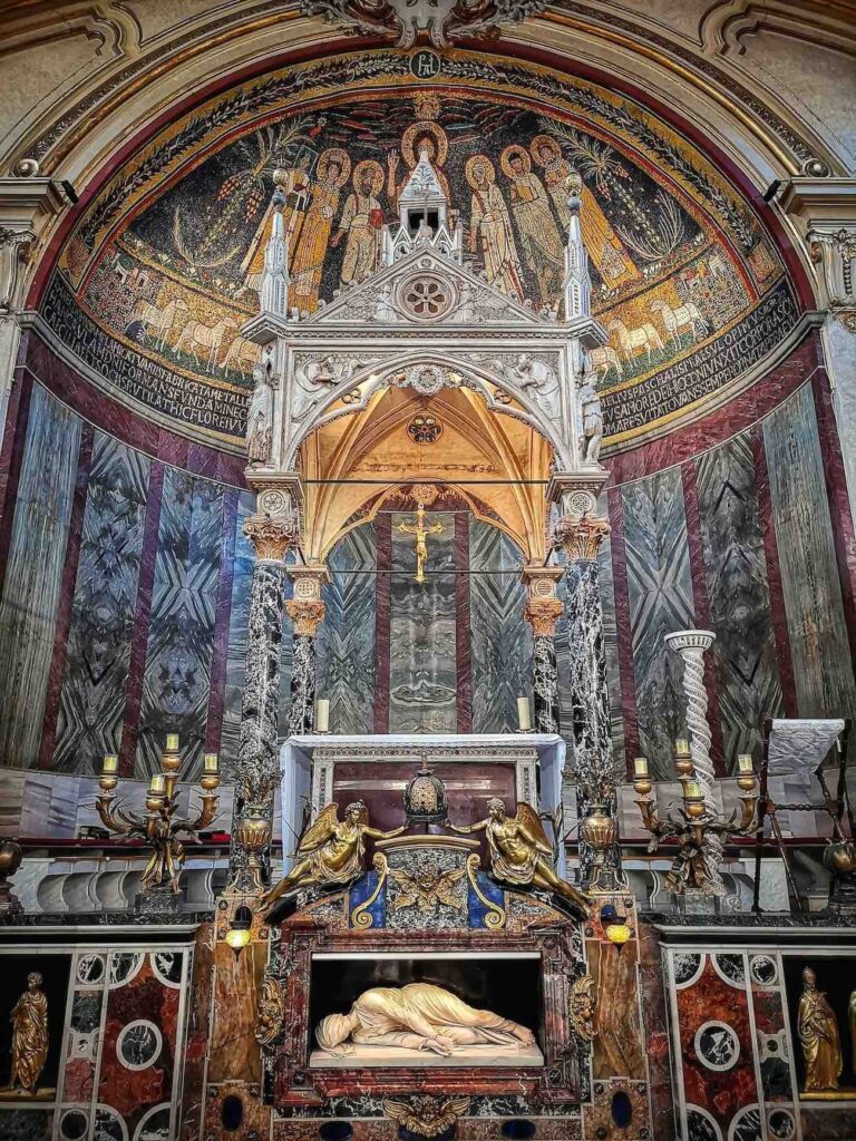 Maderno's sculpture of Saint Cecilia with the medieval ciborium and apse fresco behind