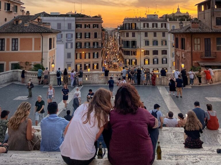 a couple enjoy sunset on the Spanish steps in Rome