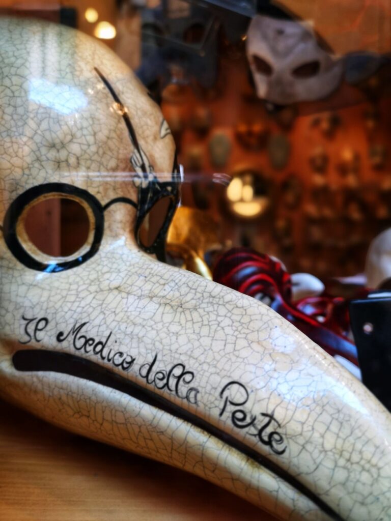 Shop window in Venice showing the Medico della Peste style Venetian Carnival mask