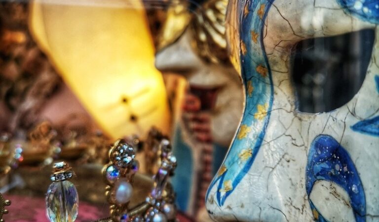 Close up detail of a Carnival mask in a shop window with blue detailing