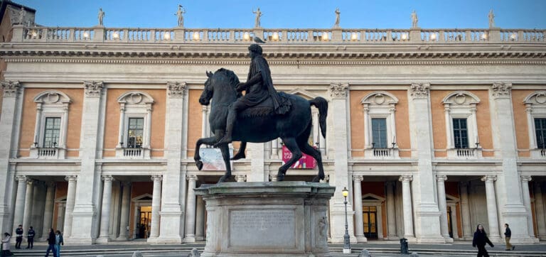 a view of the capitoline hill in rome with the statue of marcus aurelius in the foreground