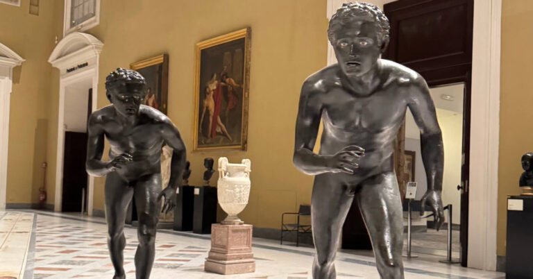 a pair of bronze runners in the galleries of the naples archaeological museum
