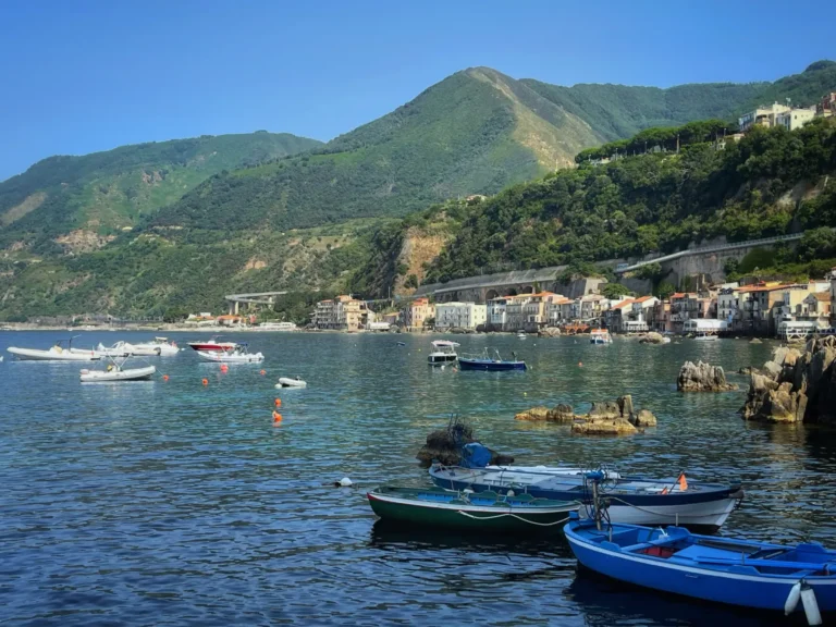 boats in the water in front of the beautiful calabrian town of Scilla.