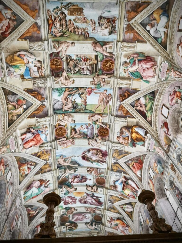 a sibyl holding a book painted by michelangelo in the sistine chapel