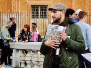 a guide gives a sistine chapel explanation