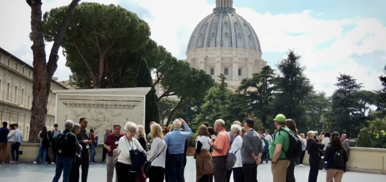 a group looks at st peters from the vatican belvedere