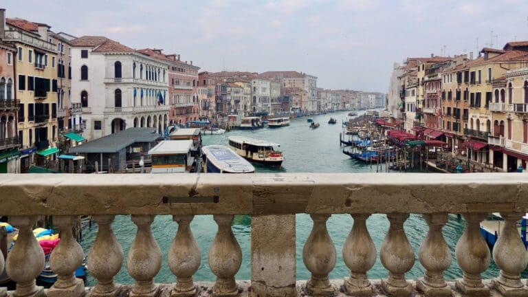 the view over venice's grand canal from the rialto bridge