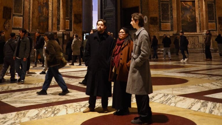 visitors gaze up at the interior of the pantheon in rome