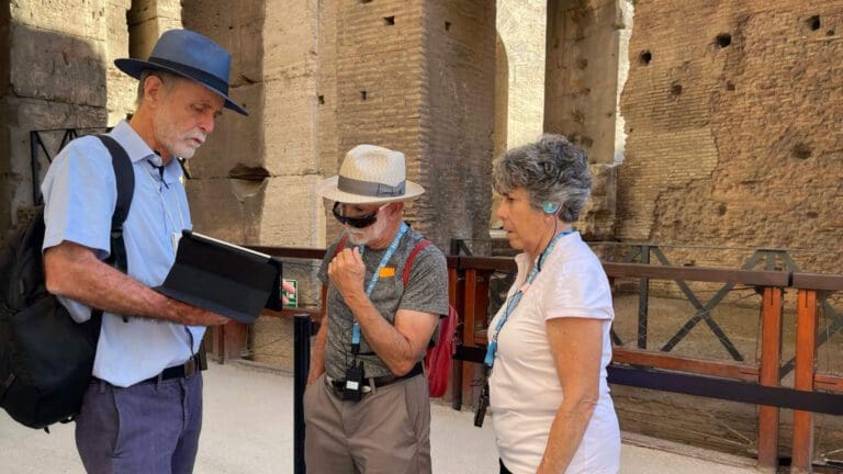 a colosseum guide shows clients reconstructions on an ipad