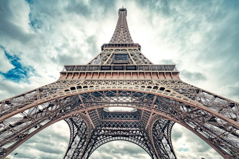 The Eiffel Tower shot from right beneath its primary arch